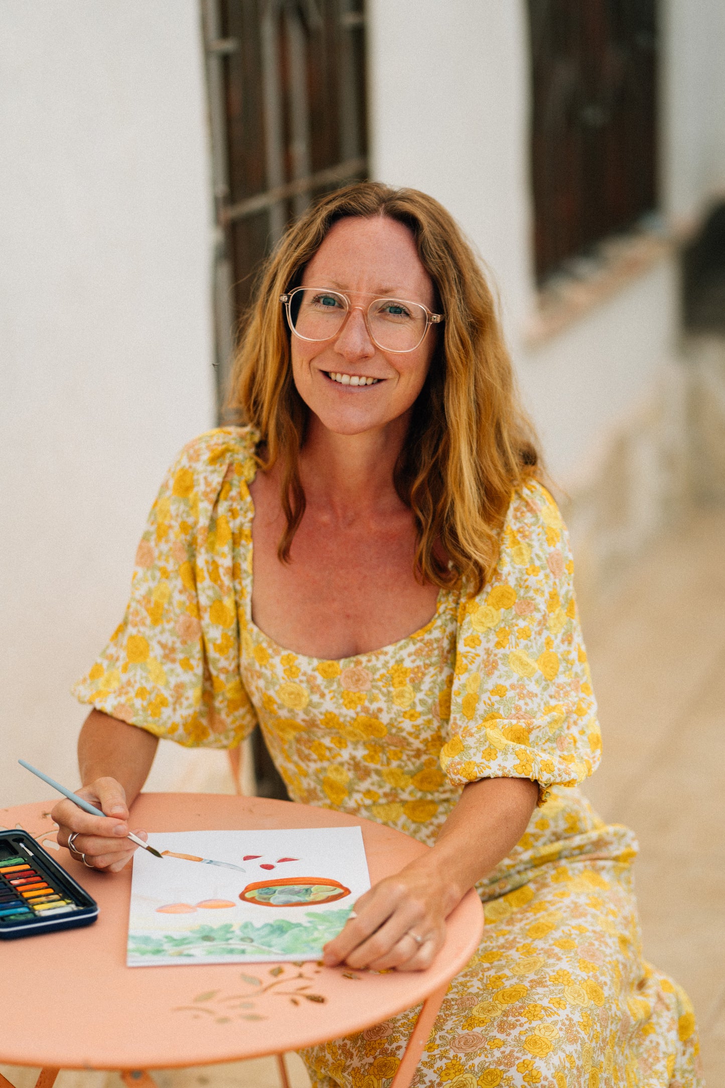 Tamar painting a watercolour illustration of figs and wine, available as an art print