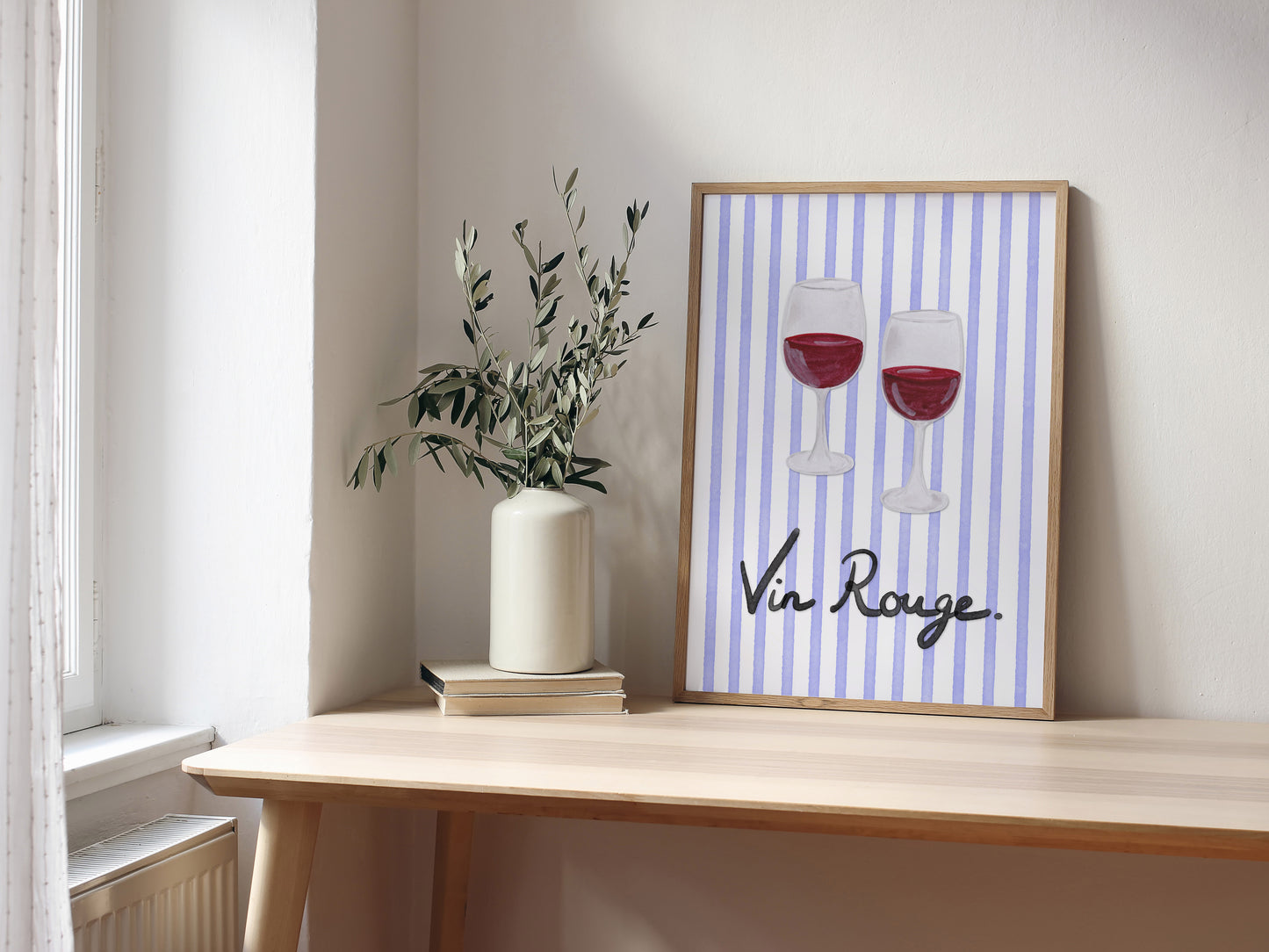 Framed artwork with 'Vin Rouge' text and wine glass illustration on a wooden shelf.