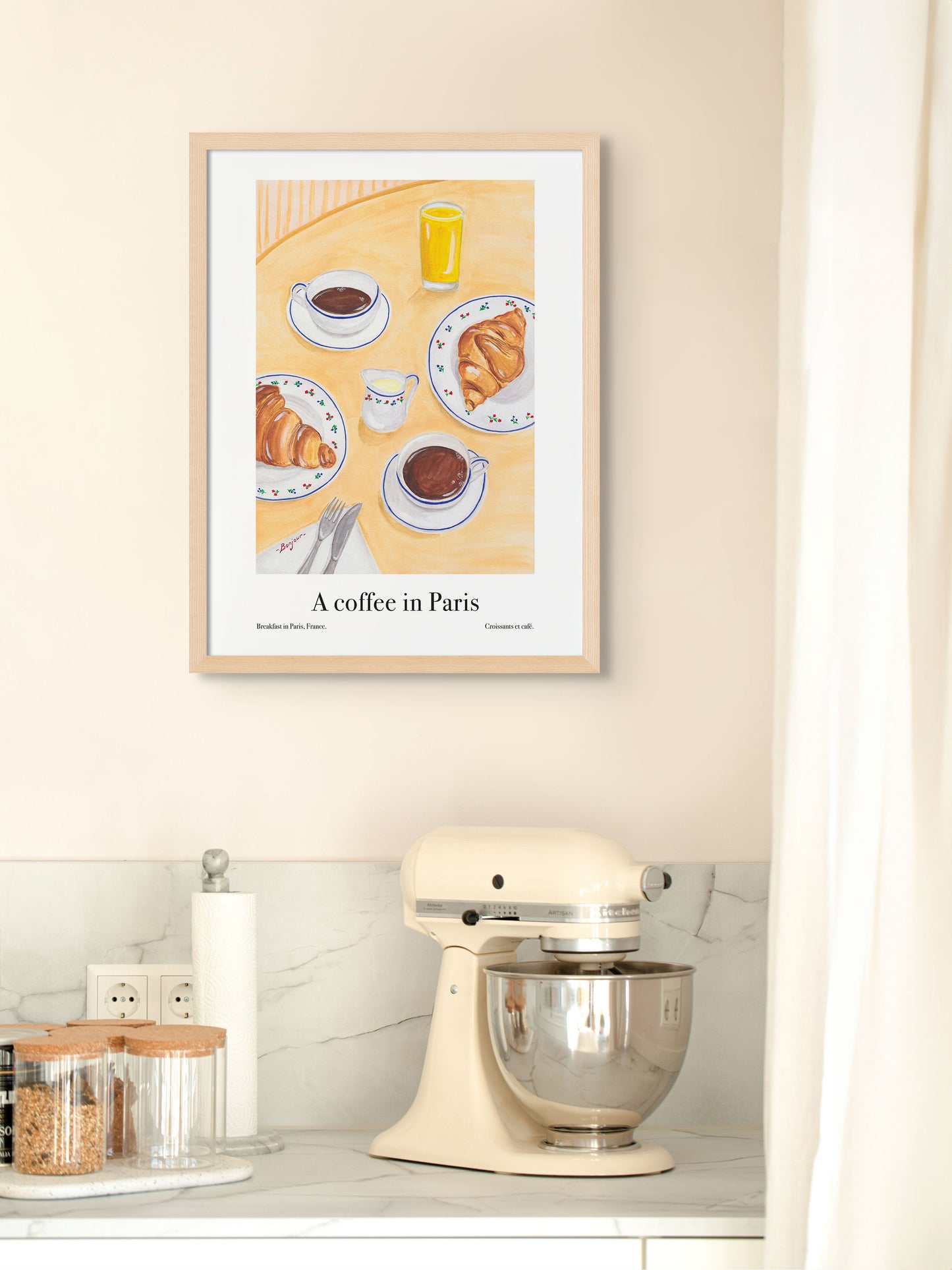 Art poster of coffee and croissants in Paris framed on a kitchen wall.