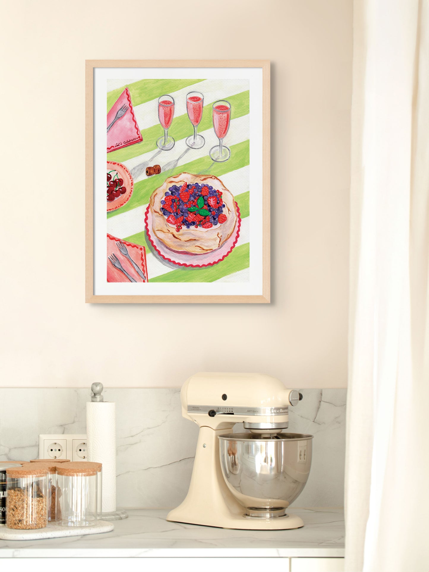 A kitchen with an art print of a table with Pavlova and rose bubbles on the wall.