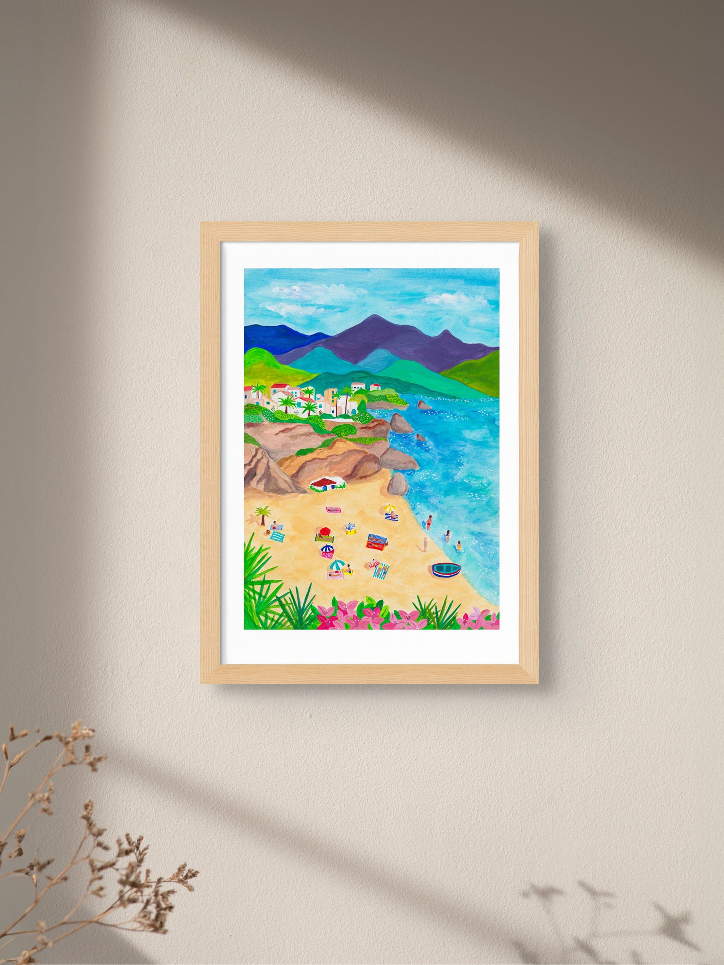 An art print of a beach scene in Nerja, Spain, framed on a wall.