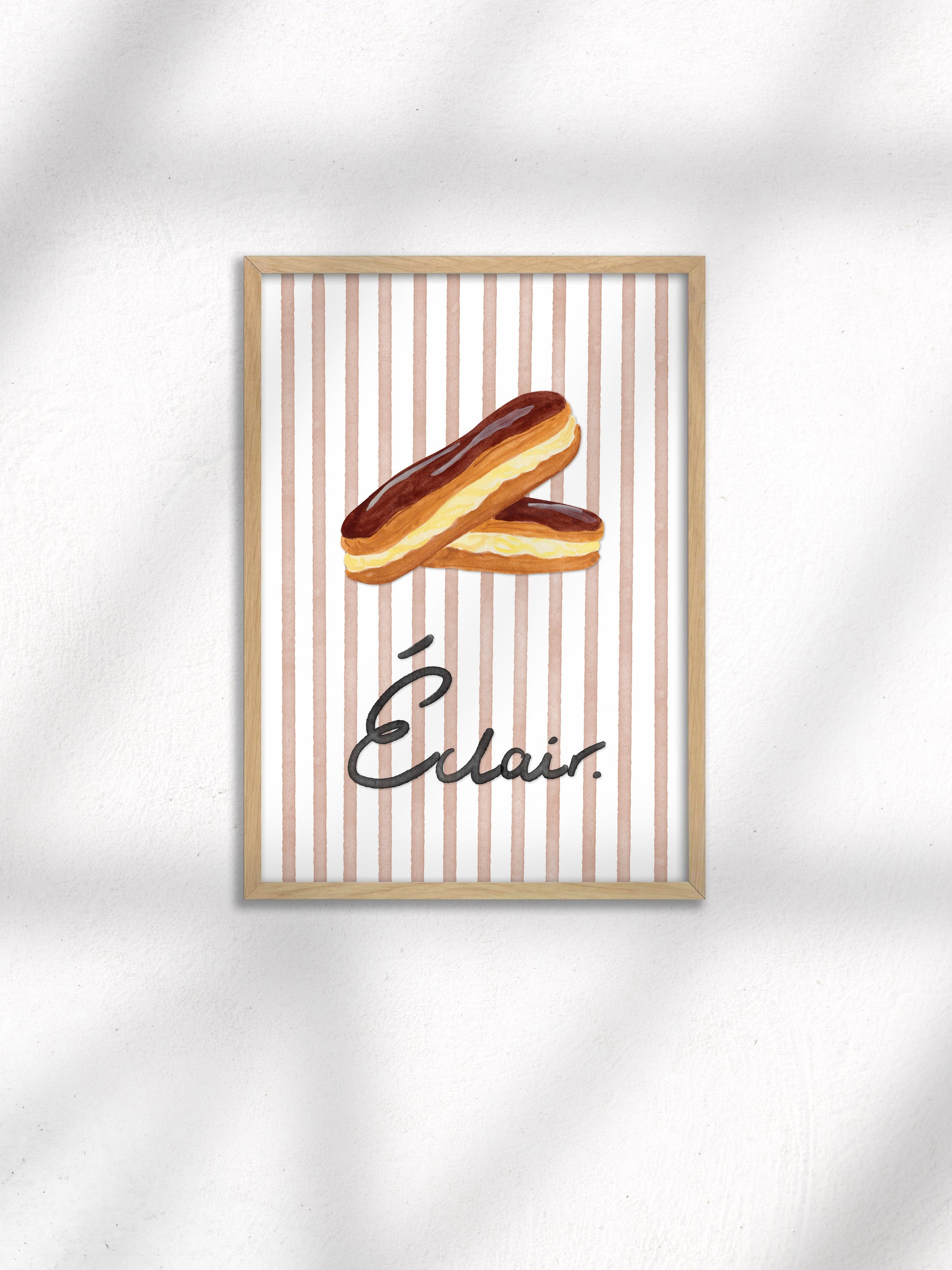 Framed artwork of two Eclairs on brown stripes