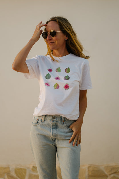 A woman wearing a white t-shirt with hand-painted figs