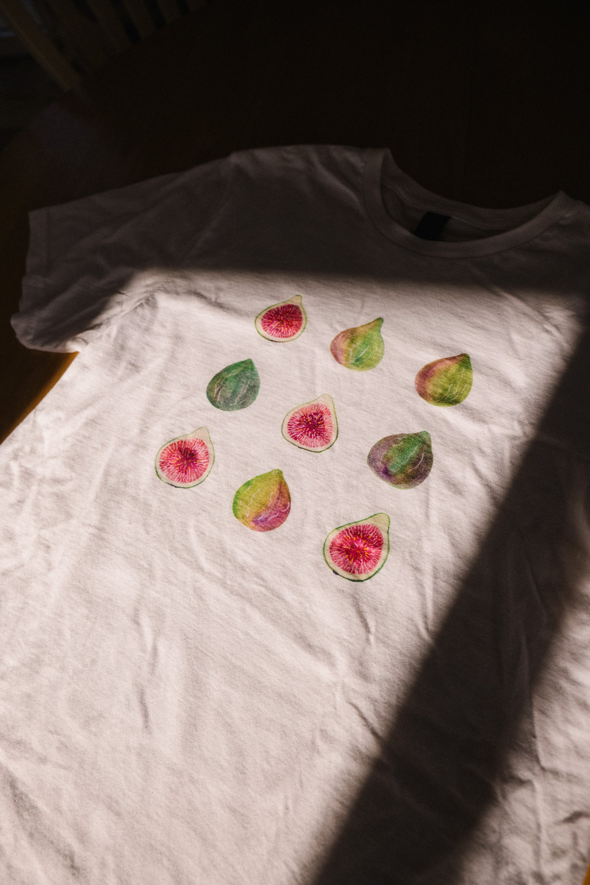 Hand-painted fig tee flat lay