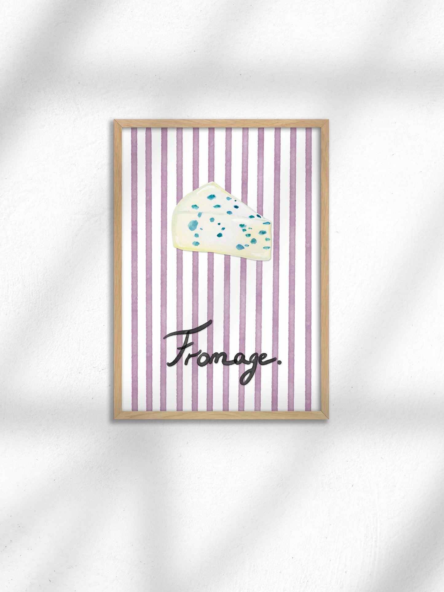 Framed artwork with a cloud illustration and the word 'Fromage' on a striped background.