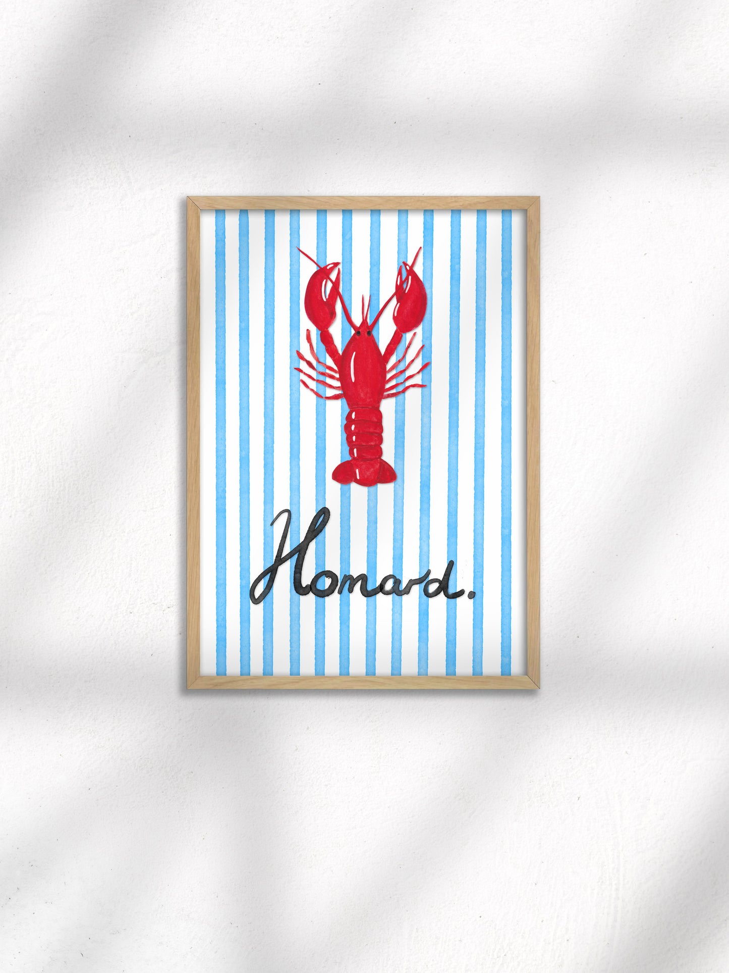 Framed artwork with a red lobster and 'Homard' text on a blue striped background