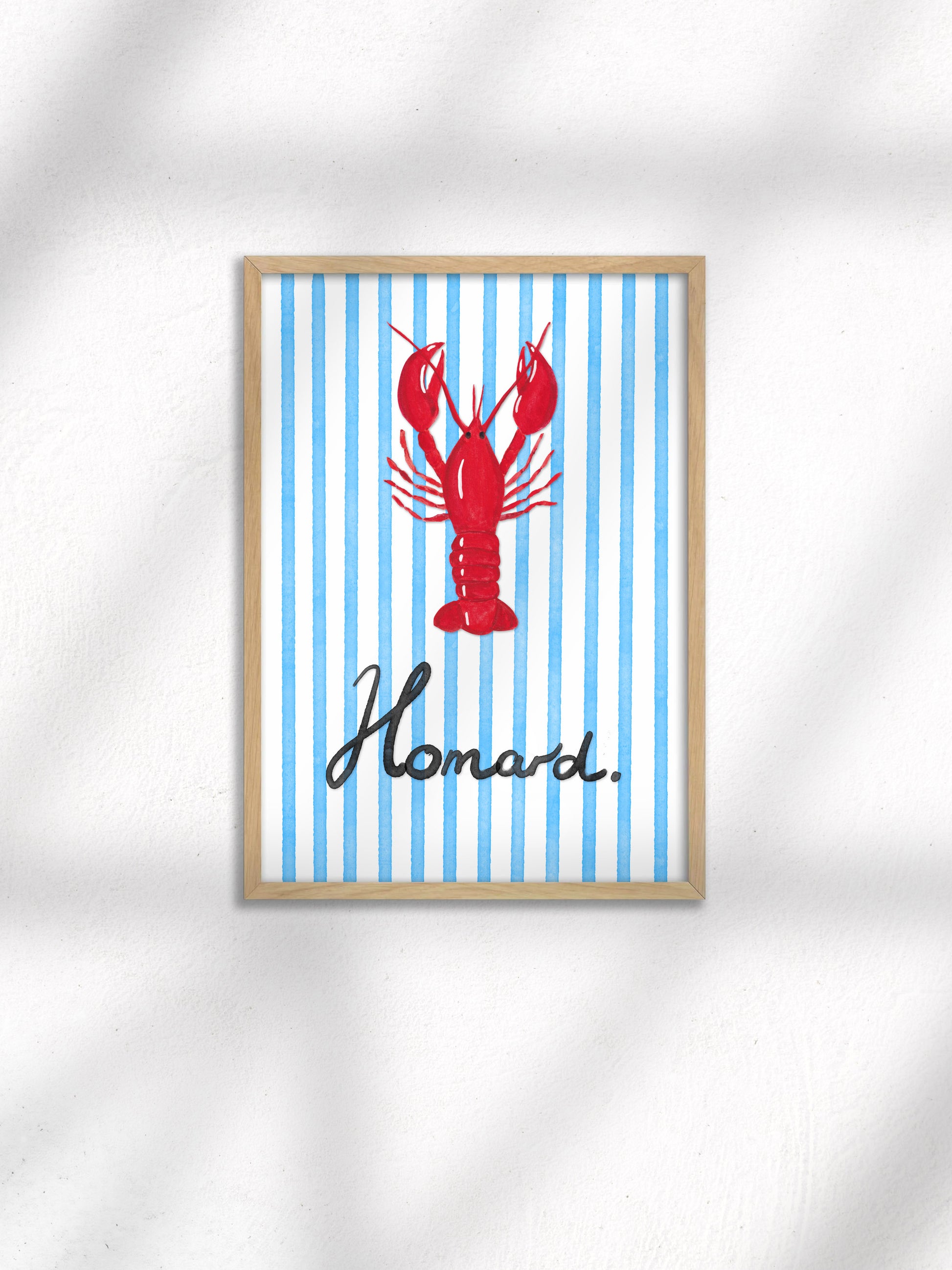 Framed artwork with a red lobster and 'Homard' text on a blue striped background
