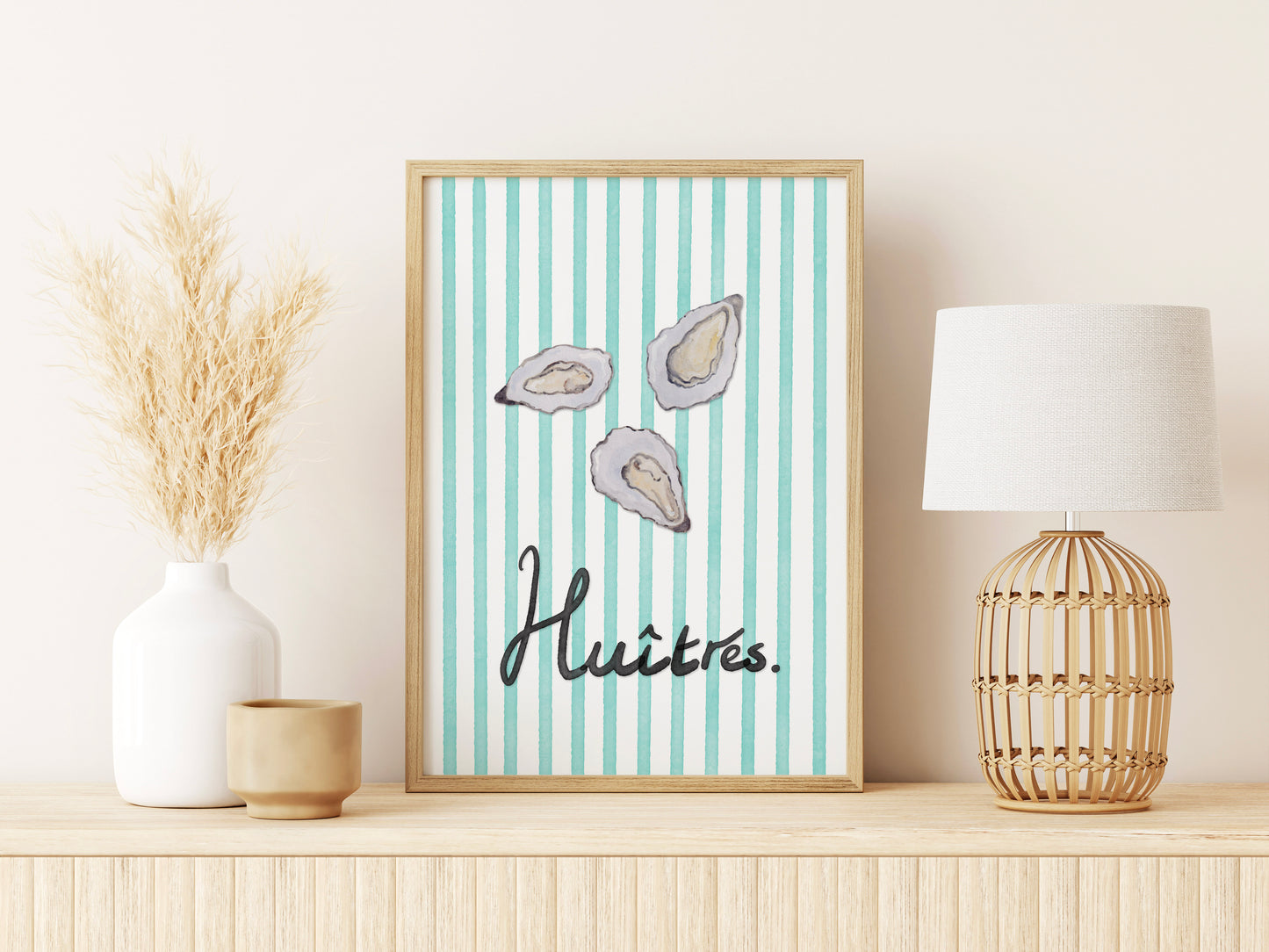 Framed artwork with oyster illustrations and text on a shelf with decor items.