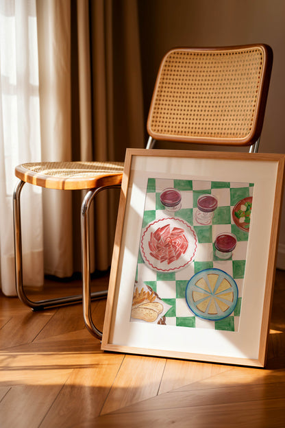 A framed art print of a table in Spain with ham and cheese and wine and a green and white checkered table cloth, perfect for kitchen decor.