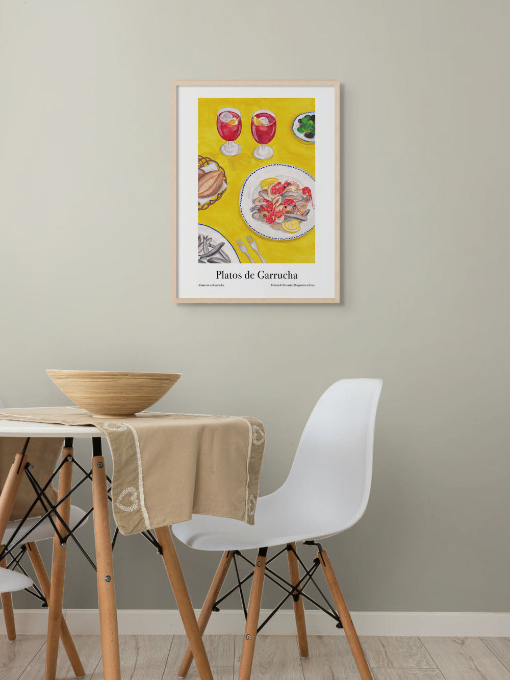 Dining room with an art poster of a table in Spain with sangria and seafood dishes on the wall.