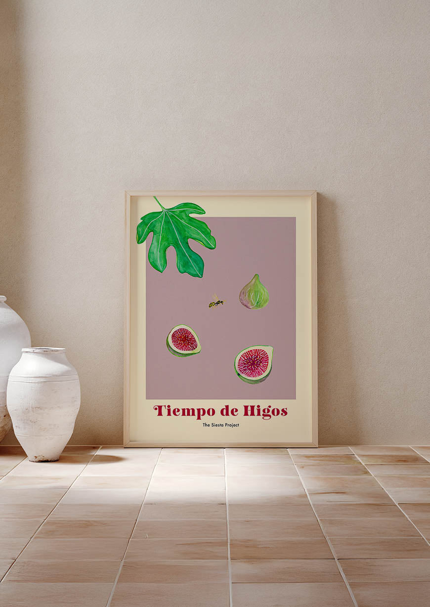 Framed artwork of figs and leaves on a wall with a vase on the floor.