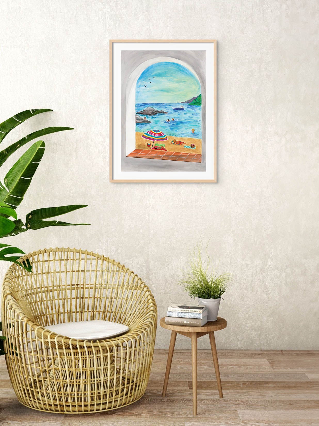 A living room with an art print of a beach on the Costa Brava in Spain on the wall.