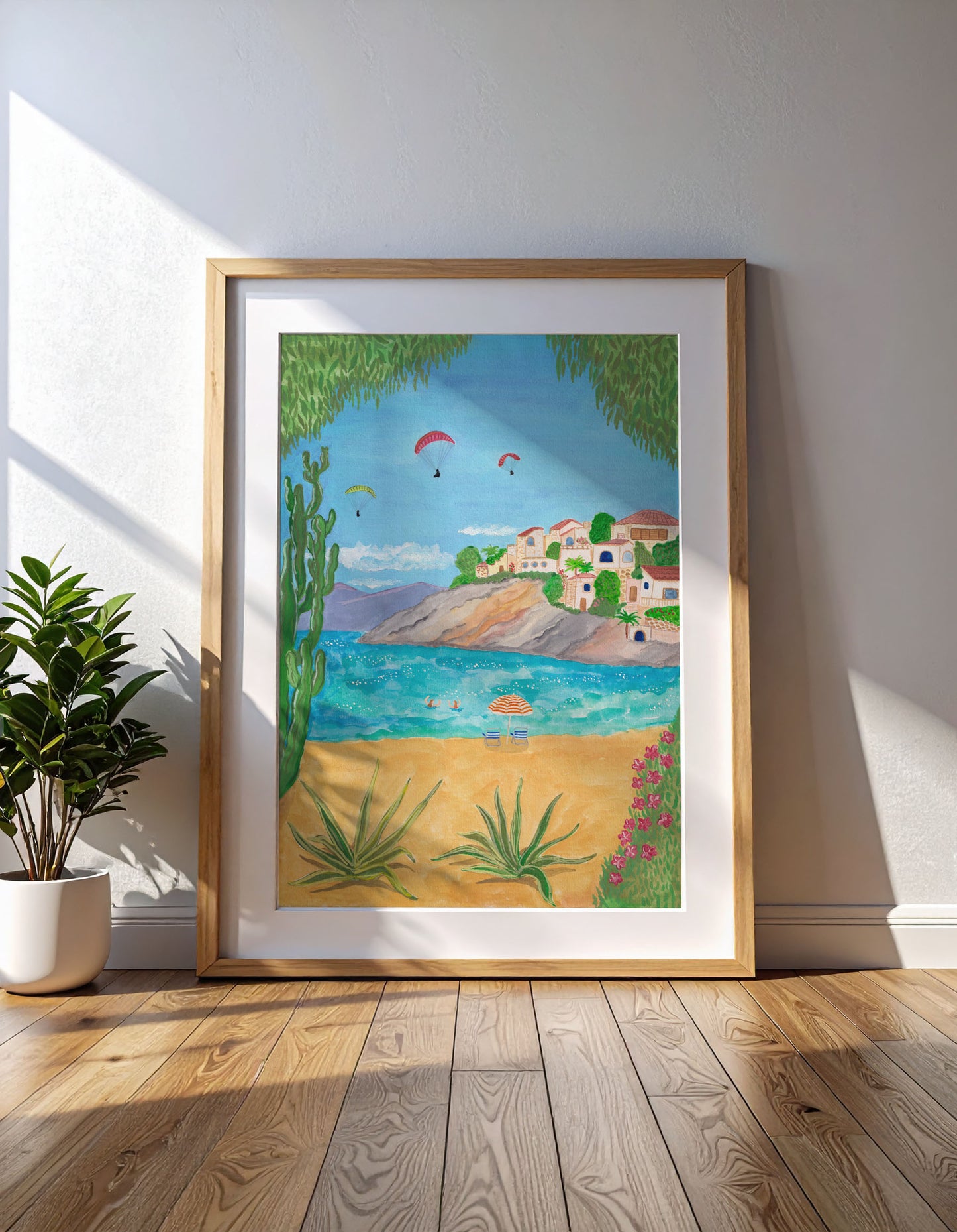 Framed artwork of a beach scene with houses and trees in Spain.