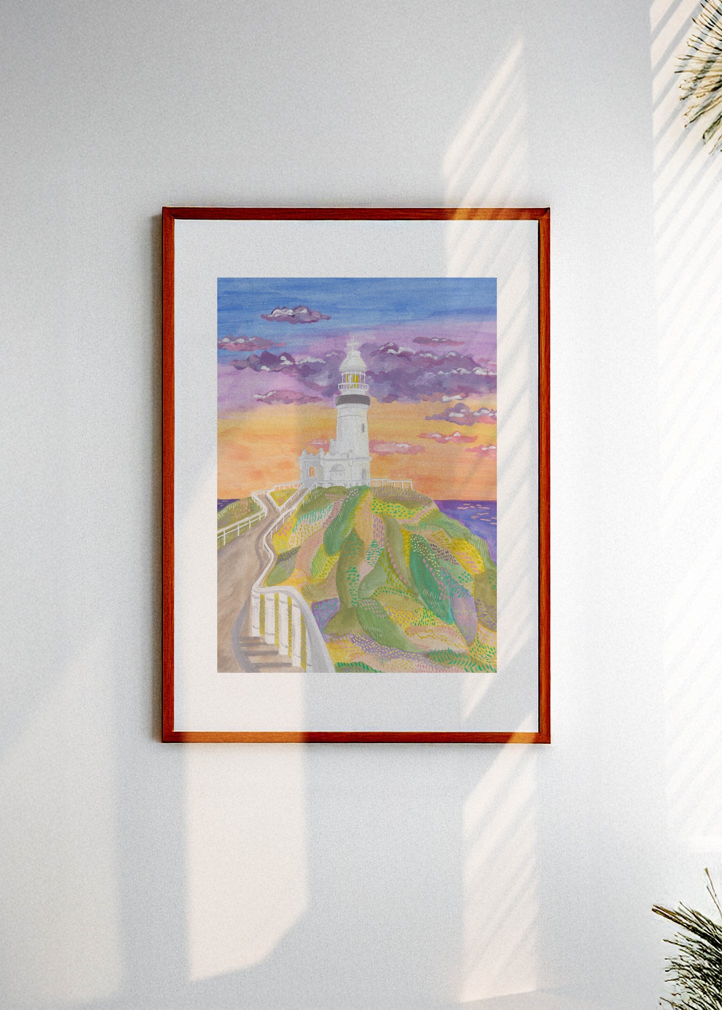 Framed artwork of the Byron Bay lighthouse in Australia on a white wall