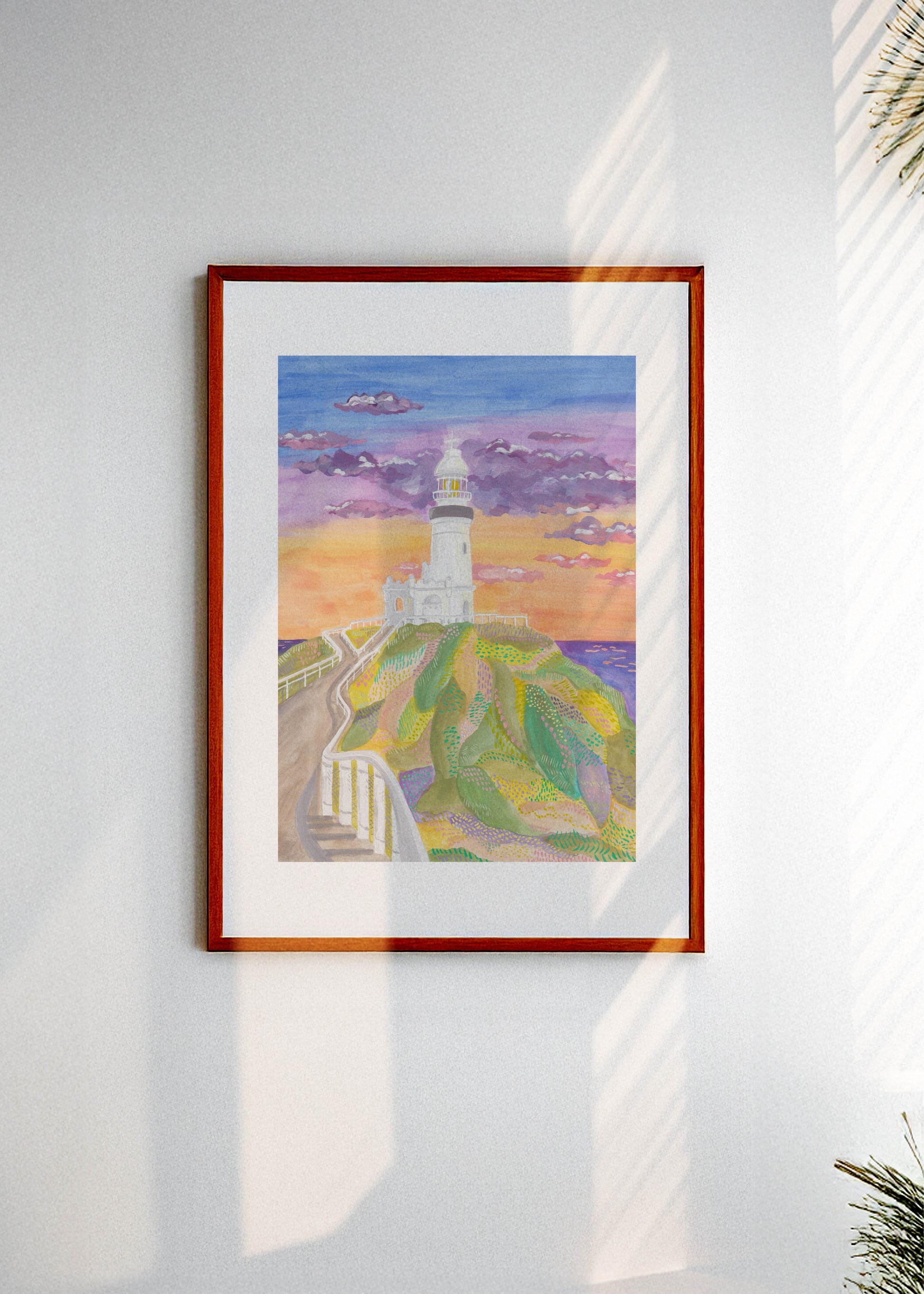 Framed artwork of the Byron Bay lighthouse in Australia on a white wall